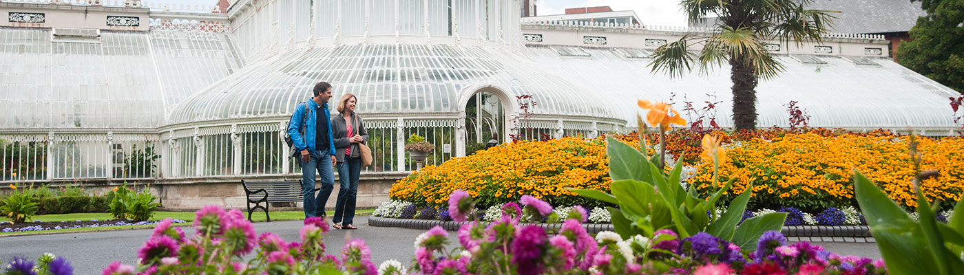 A couple walking through the Botanical Gardens in Belfast