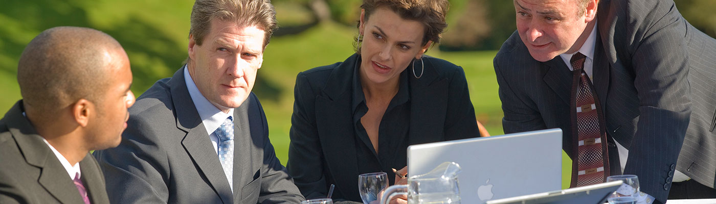 Four people having an outdoor business meeting