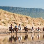 A family horseback riding in Sligo